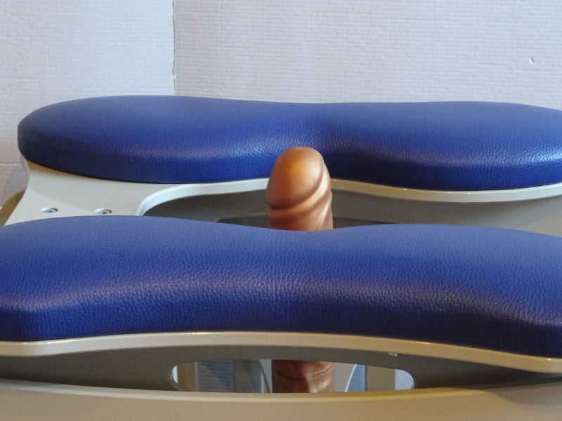 Close-up of the Joyrider Orgasm Machine by 1ATOYS, blue padded seat, with mounted dildo.