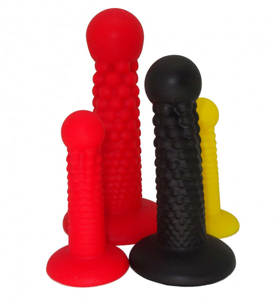 Four differently sized premium silicone dildos in red, black, and yellow by 1ATOYS, featuring the innovative Cannonball dildo design.