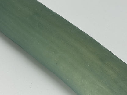 Premium silicone sex toy "The Horny Cucumber" by 1ATOYS in green. Close-up of the surface.