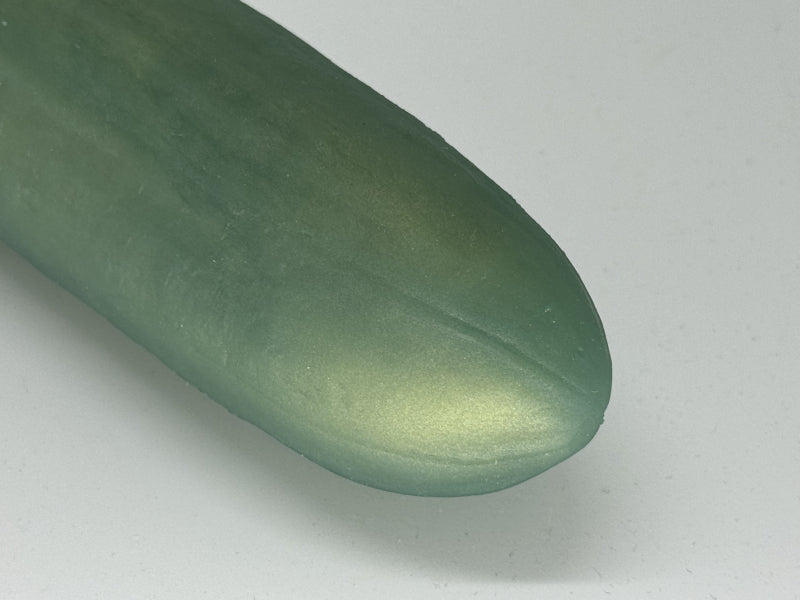 Premium silicone cucumber replica "The Horny Cucumber" by 1ATOYS in close-up, smooth green surface with textured details.