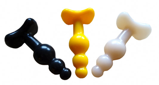 Three small plugs in black, yellow, and white made of premium silicone, ideal for beginners of the 1ATOYS Little Intruder series.